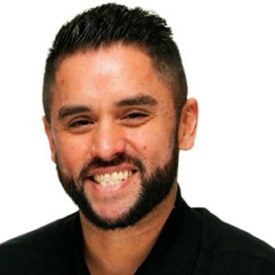 Smiling man with beard and short dark hair.